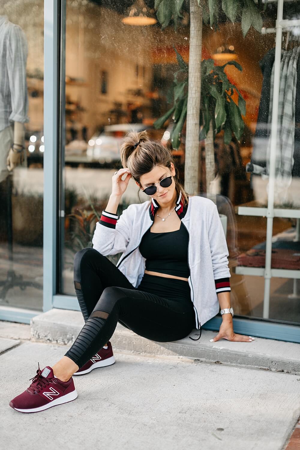 athleisure outfit all black high waisted leggings and sports bra with burgundy new balance sneakers